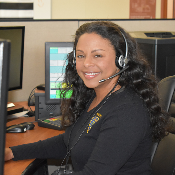 One dispatcher sitting at a desk with a headset.