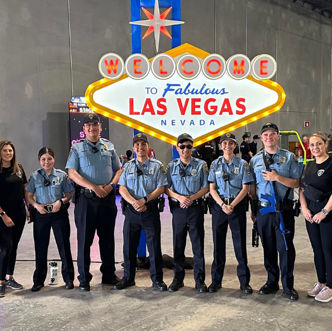 Group of police explorers standing in front of Las Vegas sign.